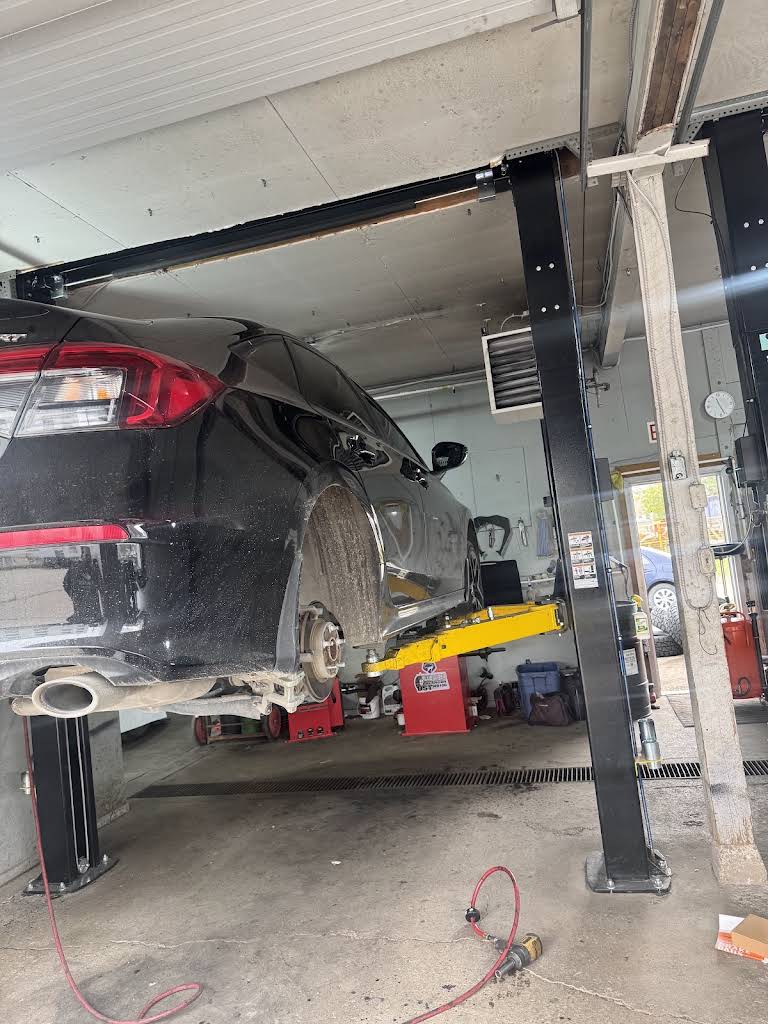 Car raised on a lift inside MasterMech Auto Care’s Winnipeg workshop